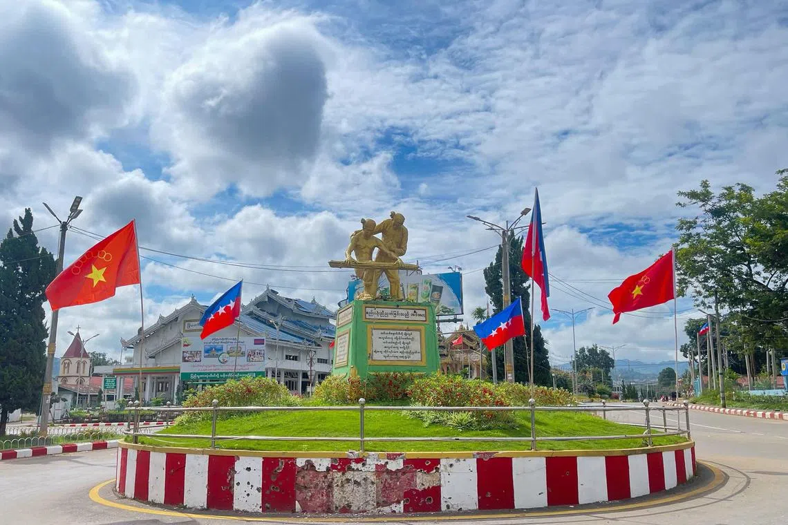 Myanmar National Democratic Alliance Army (MNDAA) ethnic armed group flags and Alliance flags raised on a damaged roundabout in Lashio in Myanmar's northern Shan state.