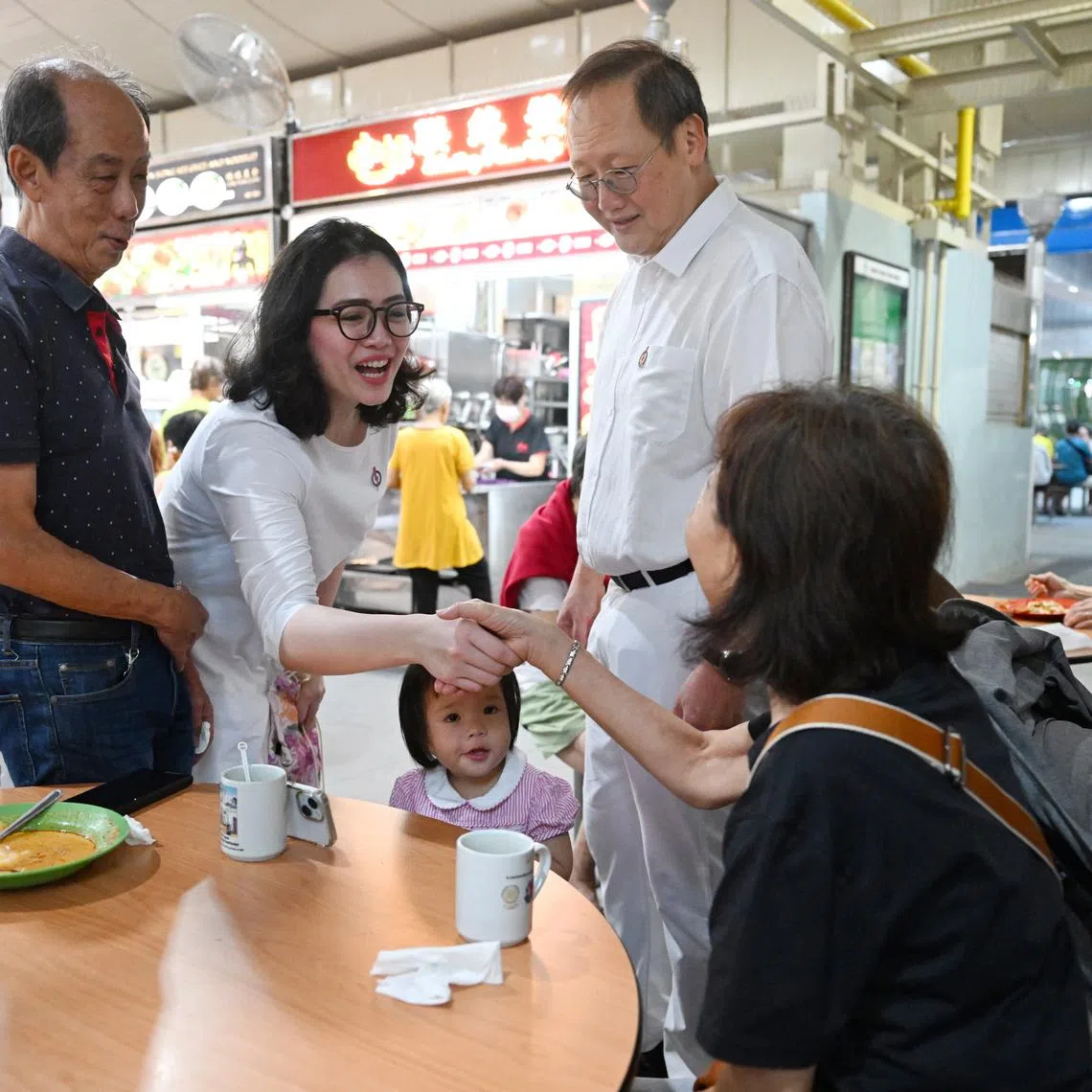 Manpower Minister Tan See Leng with PAP new face Hazlina Abdul Halim during the walkabout at 50A Marine Terrace Market on March 22.