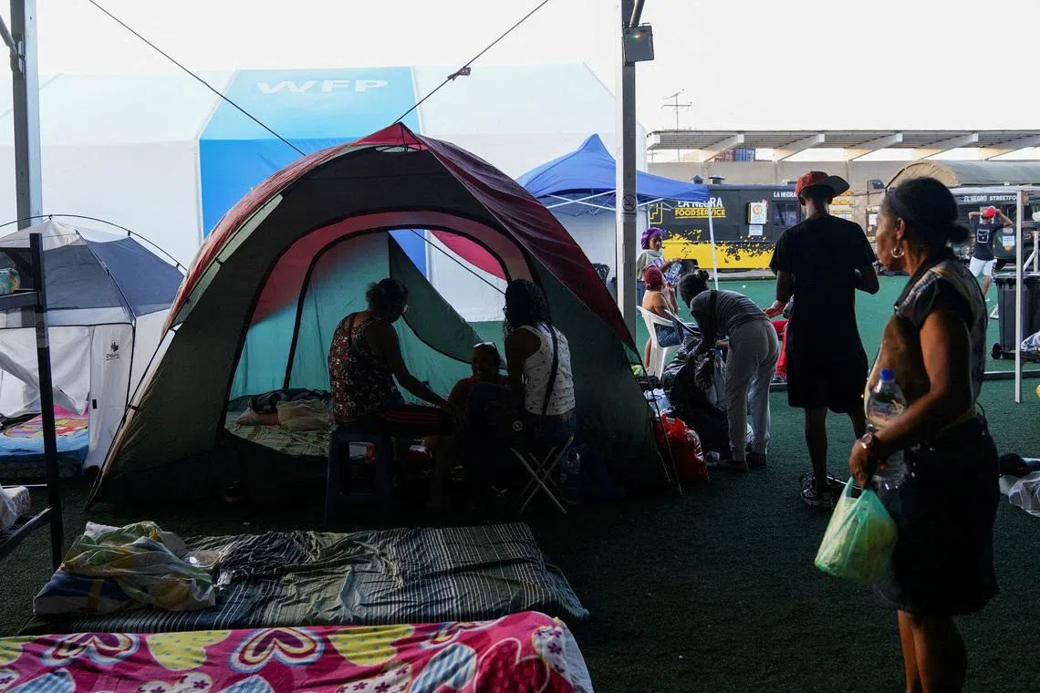 People gather near their tents at a makeshift shelter run by the UN, in the aftermath of the June 24 earthquakes, in La Guaira, Venezuela, on July 7.