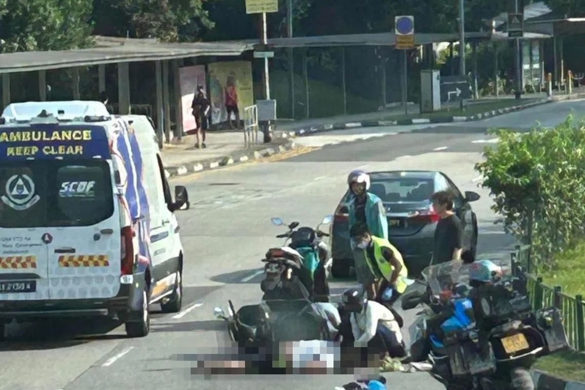 A man could be seen lying face down on the road next to a fallen bike in photos of the accident's aftermath.