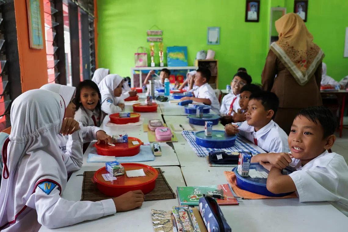 Pupils attending a free lunch programme trial at an elementary school in Tangerang, Indonesia, in August.