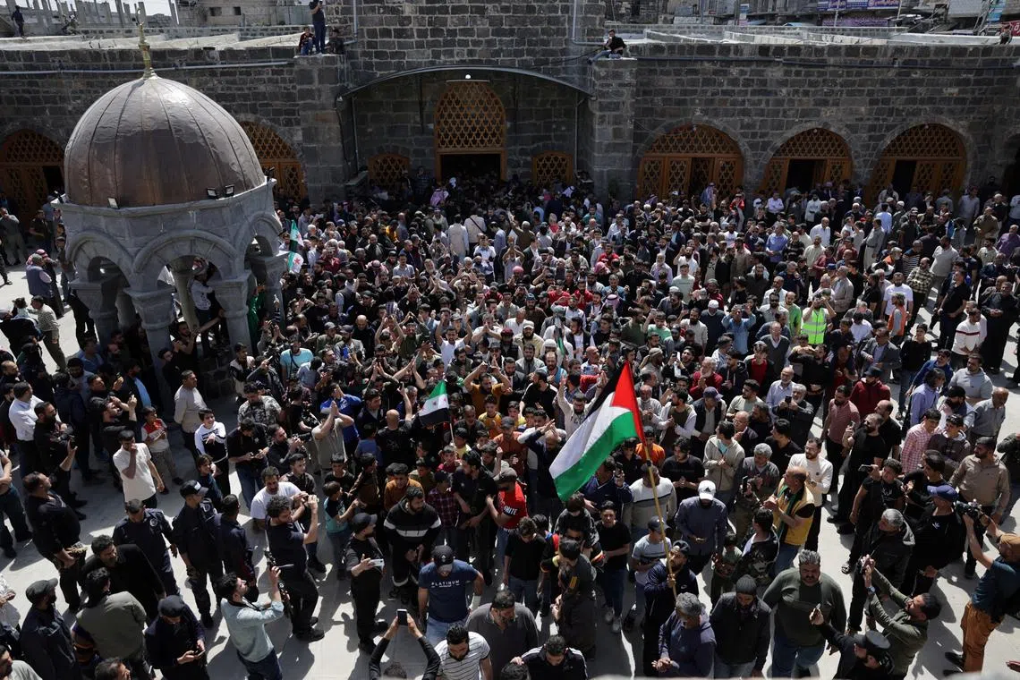 People gather during the funeral of civilians killed in an Israeli strike on Monday, in Daraa, Syria March 18, 2025. REUTERS/Khalil Ashawi