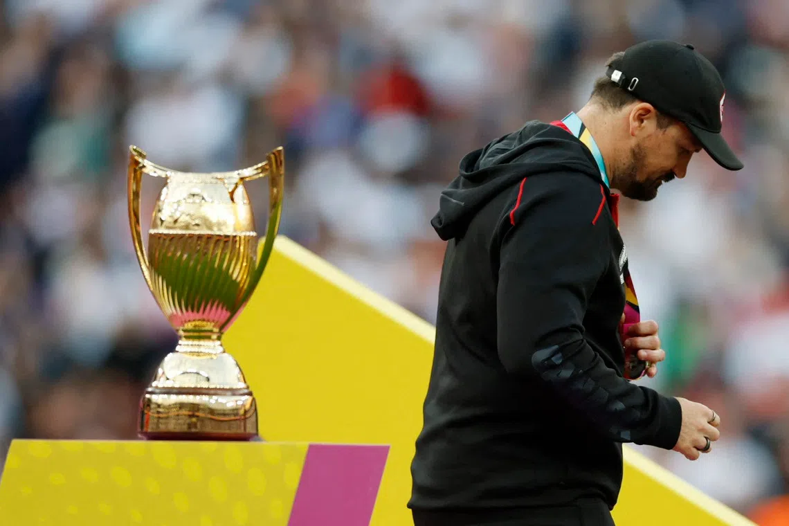 Rugby Union - Women's World Cup 2025 - Final - Canada v England - Allianz Stadium, Twickenham, London, Britain - September 27, 2025 Canada head coach Kevin Rouet walks past the trophy with his silver medal Action Images via Reuters/Peter Cziborra