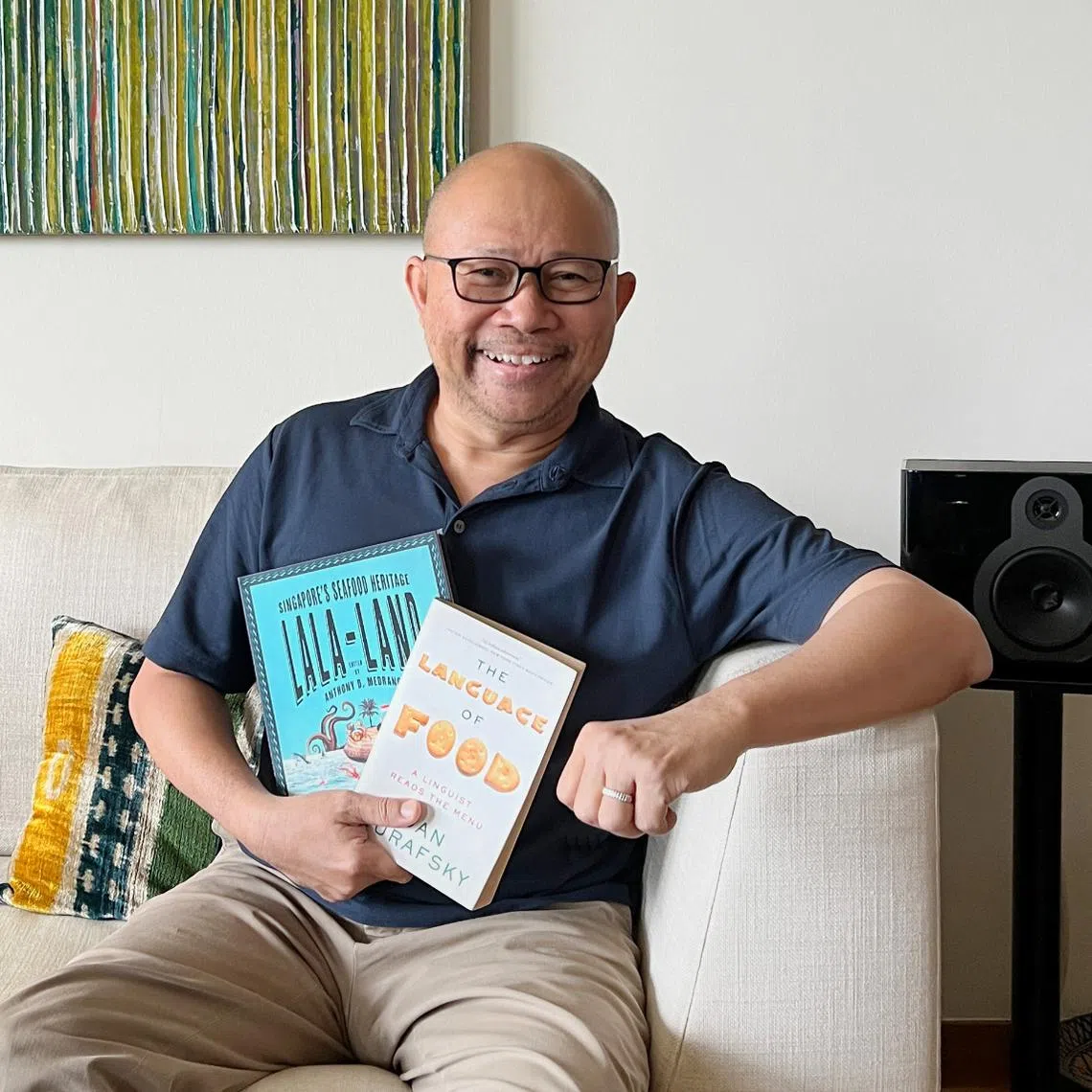 Award-winning author Khir Johari with some of the books he is currently reading.