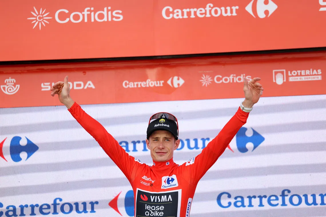 FILE PHOTO: Cycling - Vuelta a Espana - Stage 18 - Valladolid to Valladolid - Valladolid, Spain - September 11, 2025 Team Visma | Lease a Bike's Jonas Vingegaard celebrates on the -podium wearing the red jersey after stage 18 REUTERS/Juan Medina/File Photo