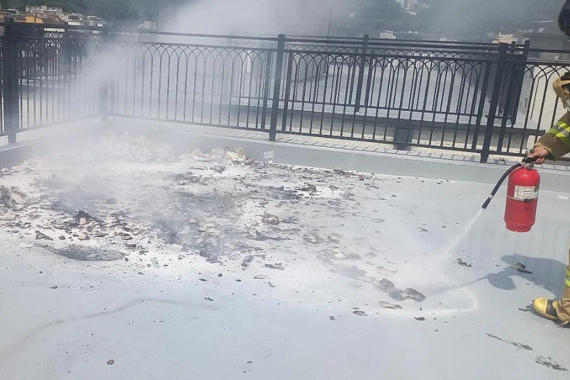 A firefighter extinguishing a trash-carrying balloon, sent by North Korea, after it fell on the rooftop of a villa in Goyang, north of Seoul, South Korea, 24 July 2024. Police presume the fire was caused by the explosion of a time detonator attached to the balloon.  