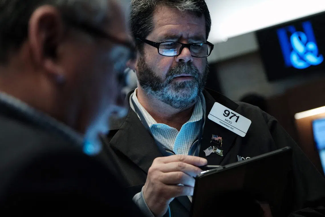 Traders work on the floor of the New York Stock Exchange.