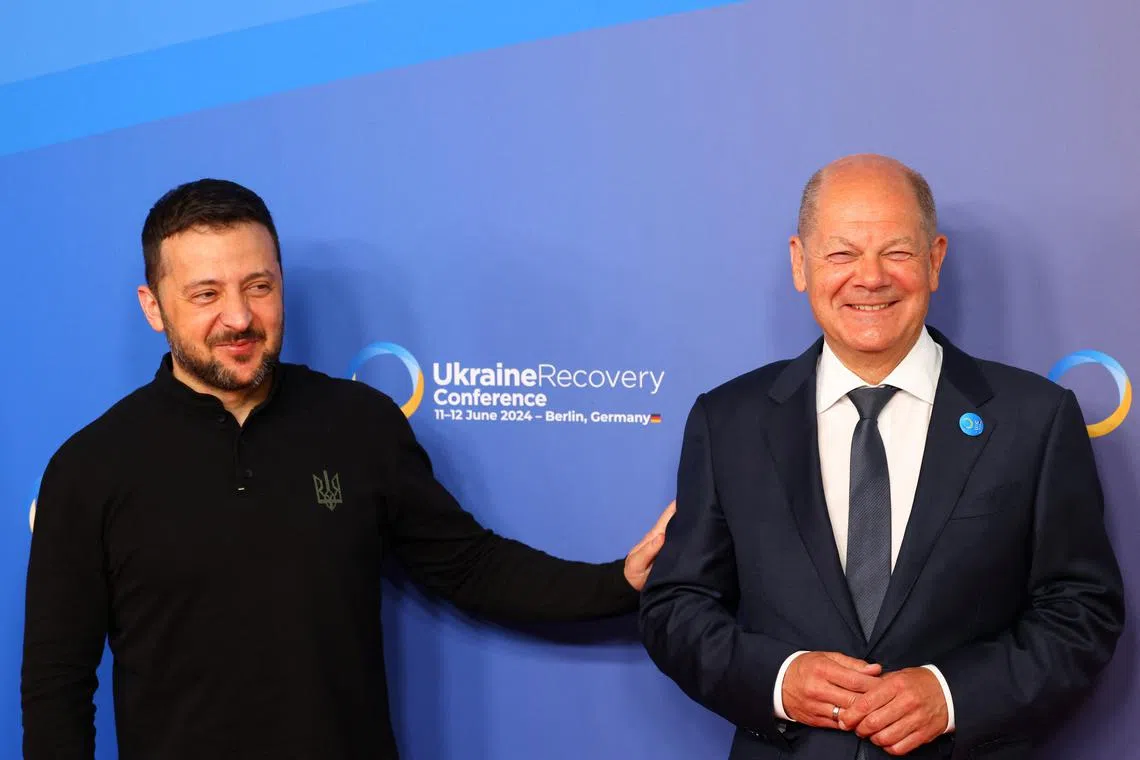 German Chancellor Olaf Scholz and Ukrainian President Volodymyr Zelenskiy pose for a picture during the Ukraine Recovery Conference in Berlin, Germany, June 11, 2024. REUTERS/Nadja Wohlleben