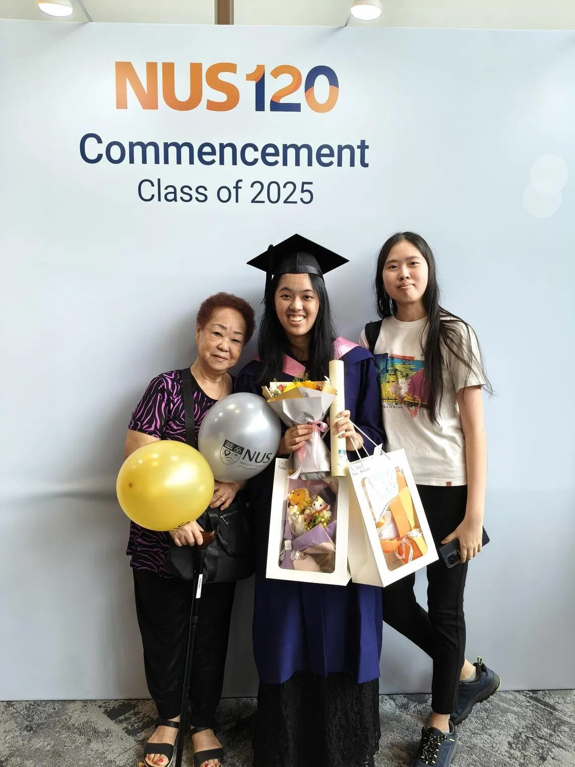 Jade with her grandmother and sister during her NUS graduation ceremony.