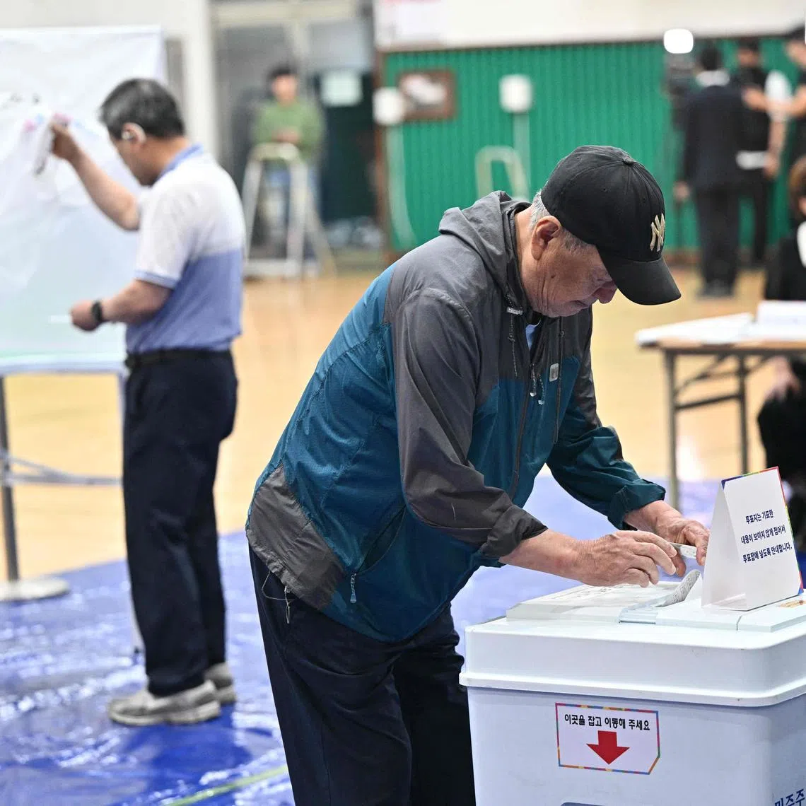 A man casts his vote at a polling station in Seoul during the presidential election on June 3, 2025. 