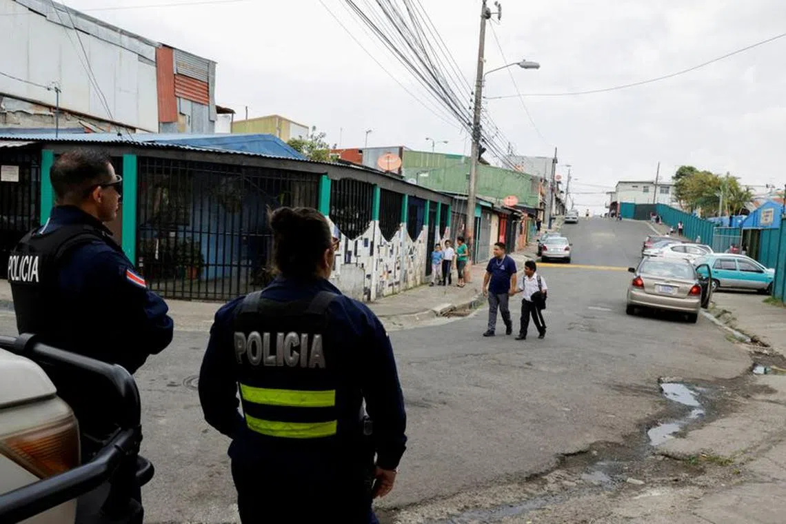 FILE PHOTO: Police officers stand guard near Ciudadelas Unidas school which is now guarded 24X7 after a series of gunfights at the neighborhood in Alajuelita town, San Jose, Costa Rica, April 28, 2023. REUTERS/Mayela Lopez/File Photo