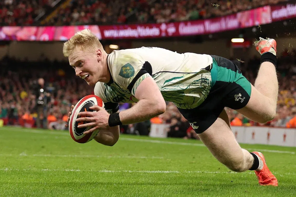 Ireland full-back Jamie Osborne dives over the line to score a try during the Six Nations match against Wales.