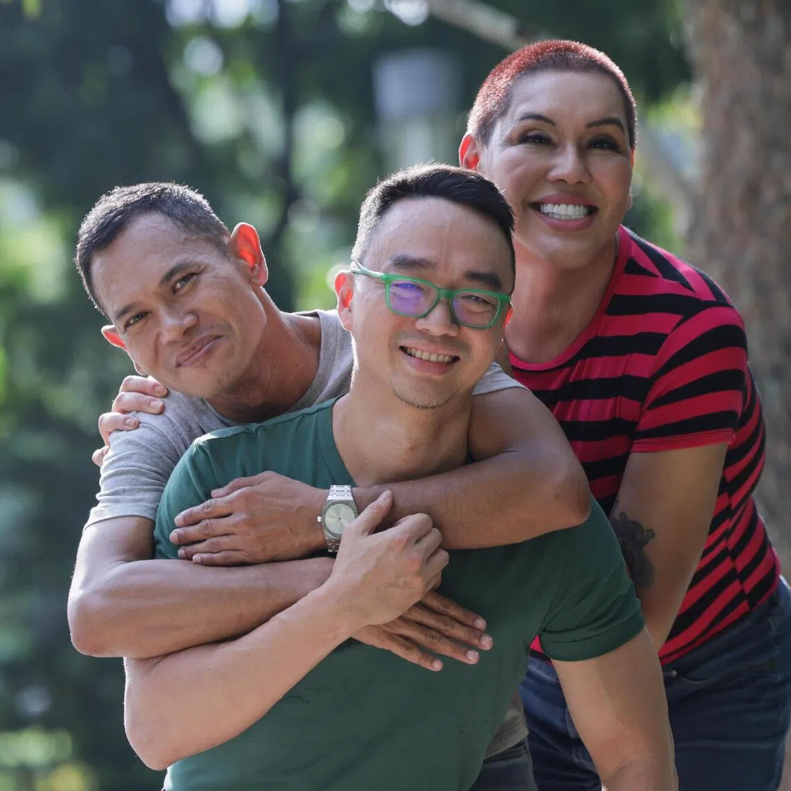 Writer and editor Jason Wee (centre), with book subjects Daniel Askre (left), and Shania Saudah, published the first book in Singapore that features LGBTQ families coming out with their stories.