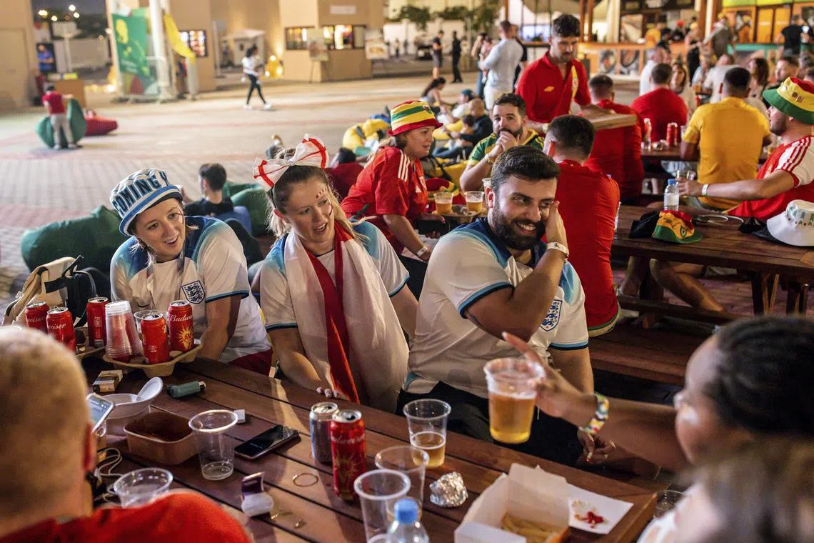 Football fans gather at a beer garden outside Al Thumama stadium in Doha before the USA v Iran match on Tuesday.  Alcohol is not allowed inside match venues. 