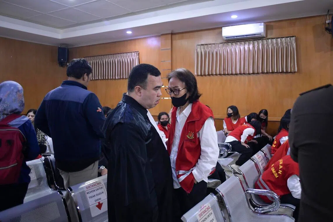 Lie speaks to her lawyer Dr Sendi Sanjaya to discuss her case after prosecutors read indictments in the case involving smuggling babies to Singapore. 