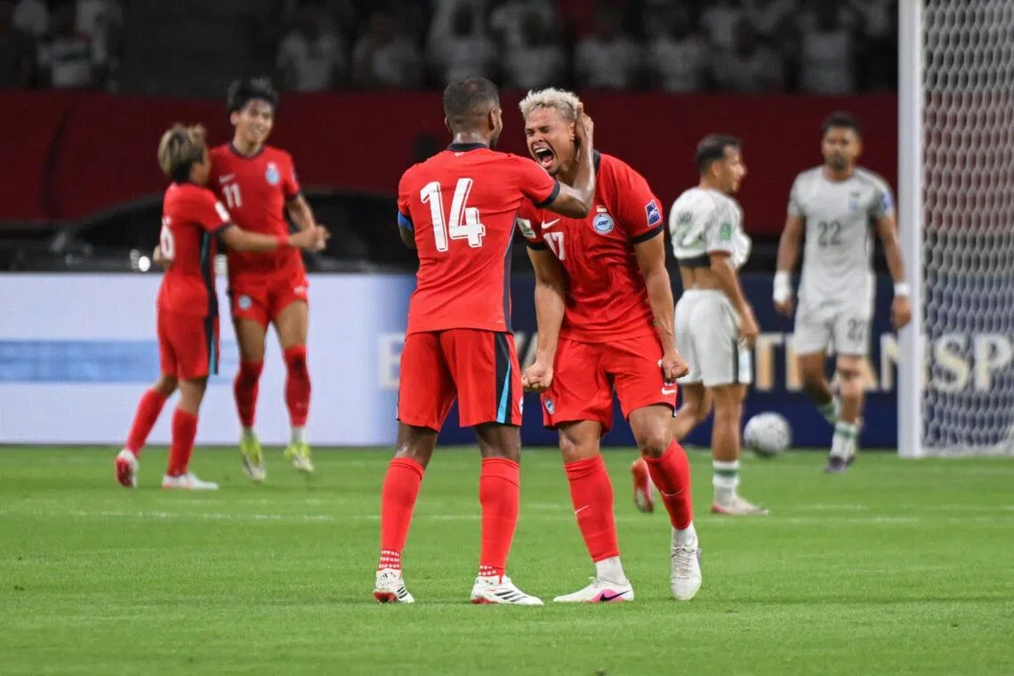 Hariss Harun (back facing) and Irfan Fandi of Singapore celebrate after Harhys Stewart scores the first goal during the AFC Asian Cup qualifier against Bangladesh at the National Stadium on March 31, 2026.