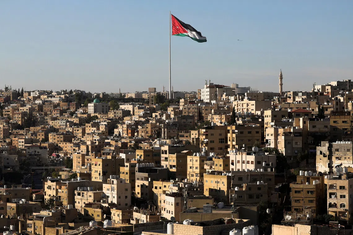 A Jordanian flag flies over the capital city, Amman, Jordan August 17, 2025. REUTERS/Mohamed Abd El Ghany
