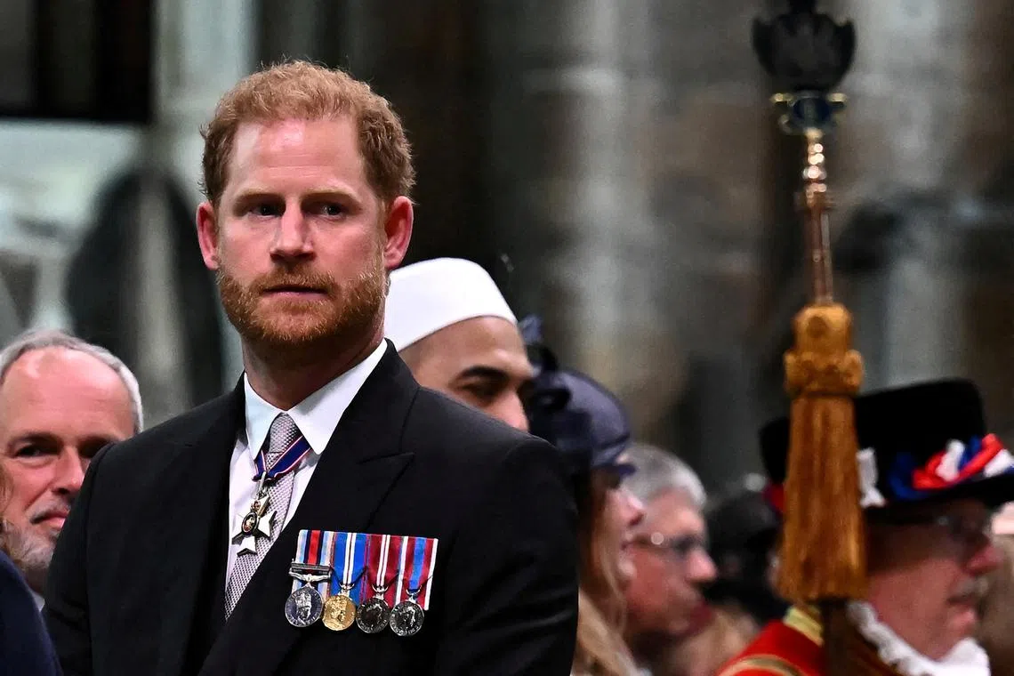 FILE PHOTO: Britain's Prince Harry, Duke of Sussex looks on as Britain's King Charles III leaves Westminster Abbey after the Coronation Ceremonies in central London on May 6, 2023. BEN STANSALL/Pool via REUTERS/File Photo
