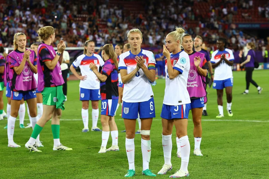 England's Leah Williamson (foreground, left) and Alex Greenwood looking dejected after their 2-1 defeat by France on July 5.
