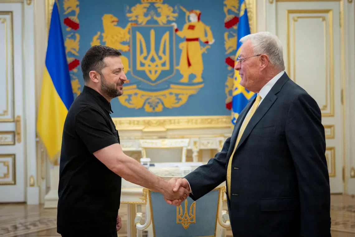 Ukraine's President Volodymyr Zelenskiy shakes hands with U.S. Special Envoy for Ukraine Keith Kellogg as they meet in Kyiv, Ukraine July 14, 2025. Ukrainian Presidential Press Service/Handout via REUTERS