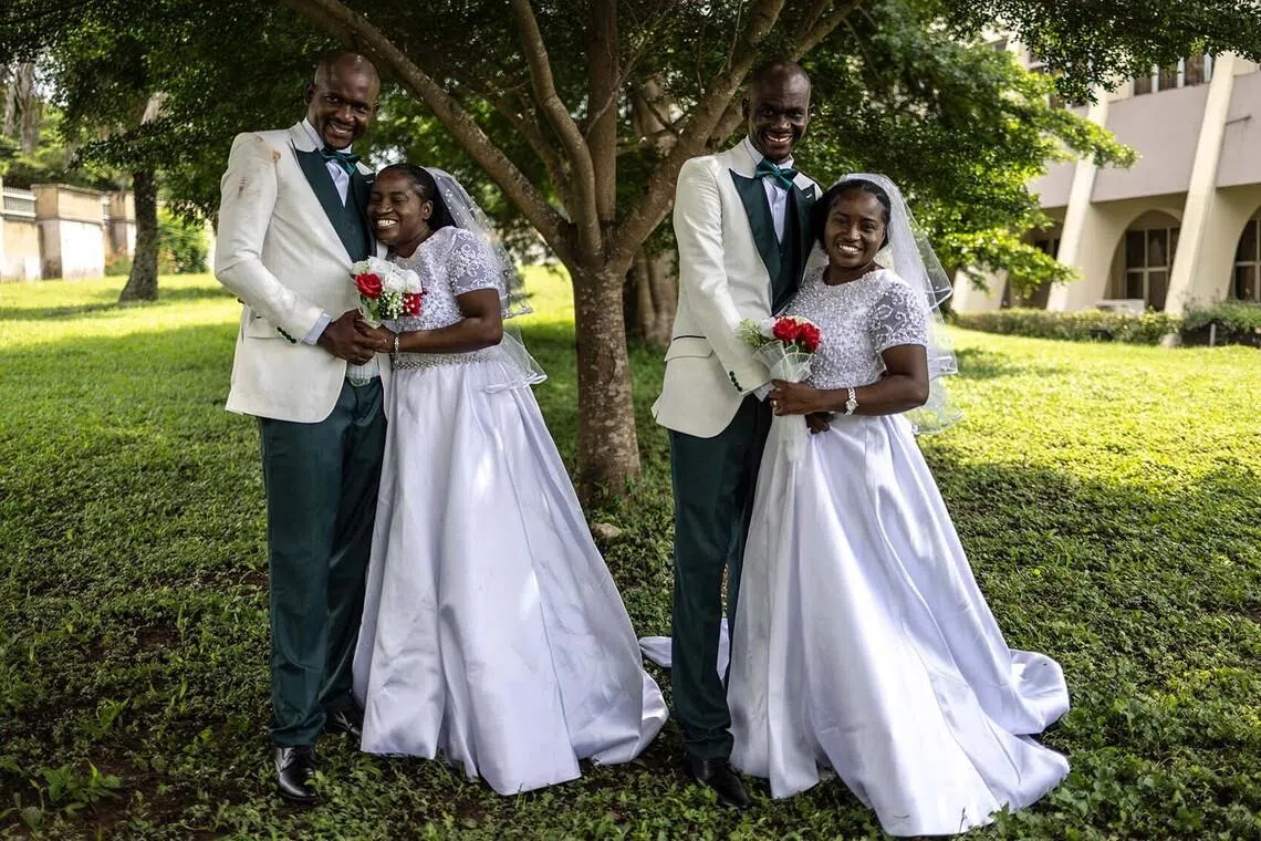 Twin sisters Taiwo and Kehinde Adediran, and twin brothers Taiwo and Kehinde Oguntoye, posing for a photograph during their wedding reception at the International Conference Center in Ibadan, Nigeria, on June 20.