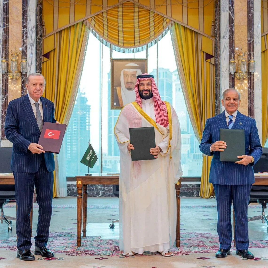 Turkish President Recep Tayyip Erdogan, Saudi Crown Prince Mohammed bin Salman, and Pakistan’s Prime Minister Shehbaz Sharif pose after signing a joint defence agreement in Mecca, Saudi Arabia, on Aug 7.
