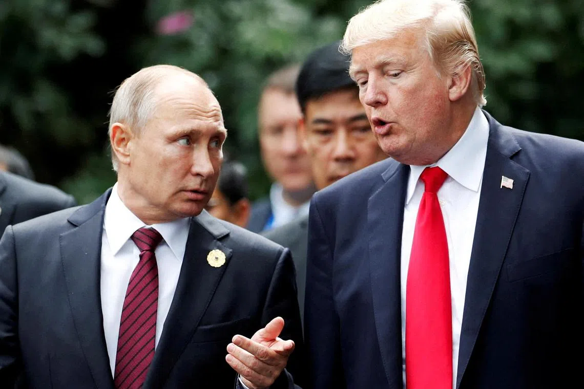 FILE PHOTO: U.S. President Donald Trump and Russia's President Vladimir Putin talk during the family photo session at the APEC Summit in Danang, Vietnam November 11, 2017. REUTERS/Jorge Silva/File Photo