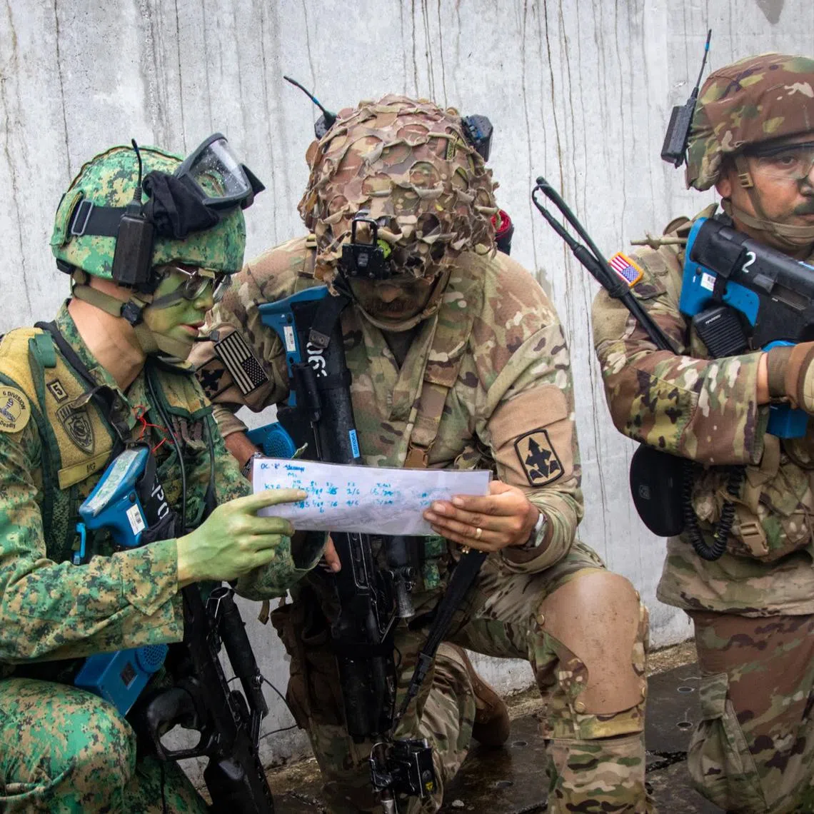 A soldier from the Singapore Army (left) working with his counterparts from the US Army during urban operations at Safti City for Exercise Tiger Balm.