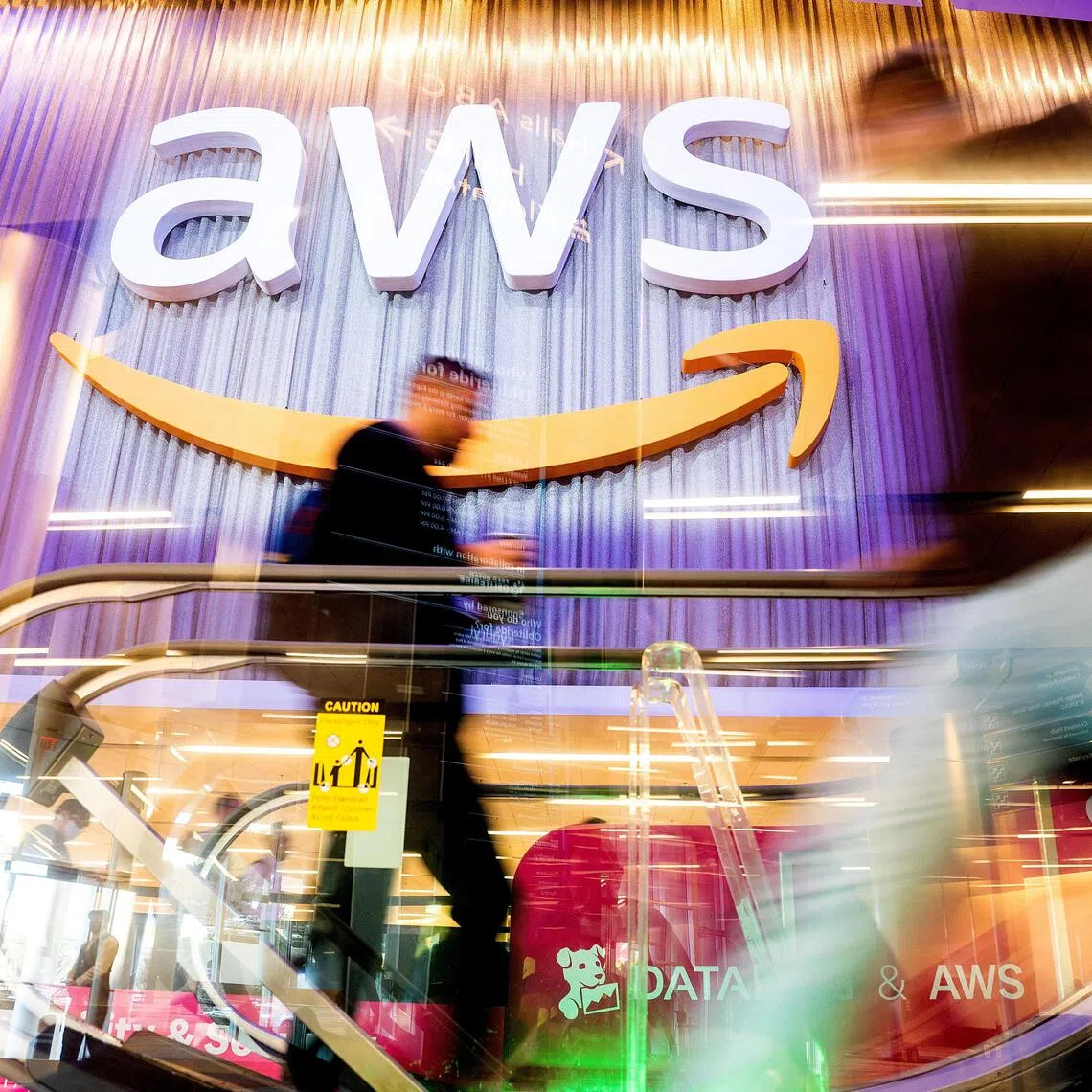 FILE PHOTO: Attendees walk through AWS re:Invent 2022, a conference hosted by Amazon Web Services (AWS), in Las Vegas, Nevada, U.S., November 30, 2022. Noah Berger/AWS/Handout via REUTERS THIS IMAGE HAS BEEN SUPPLIED BY A THIRD PARTY. MANDATORY CREDIT/File Photo