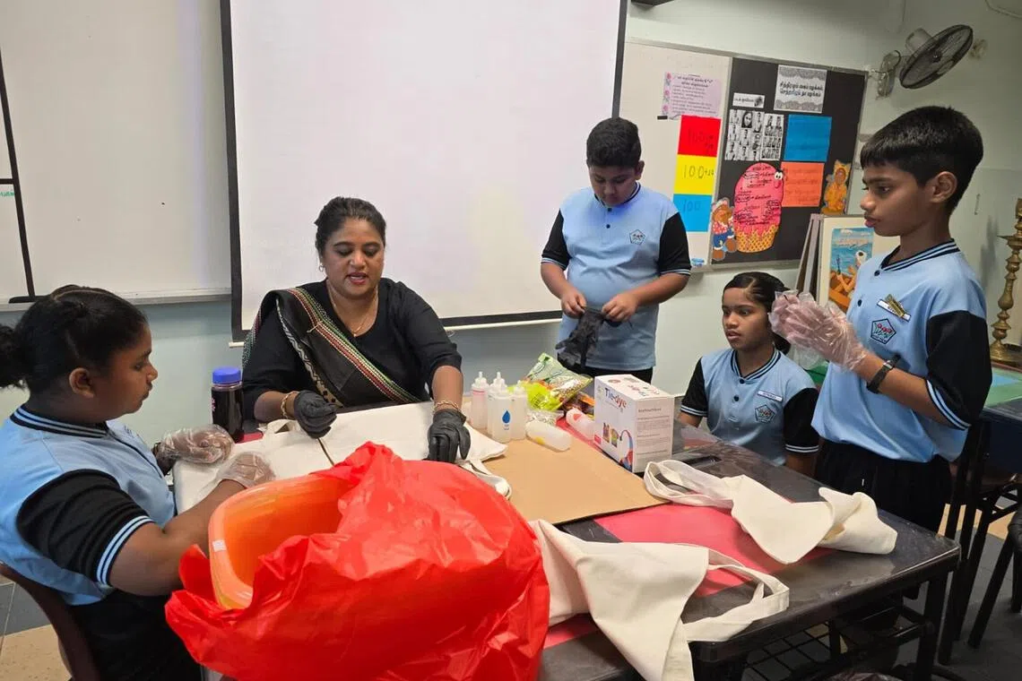 Mdm Normanisha teaching her students Bhandani, an ancient Indian tie-and-dye art form that uses tiny knots to create intricate patterns, during one of her Tamil classes.