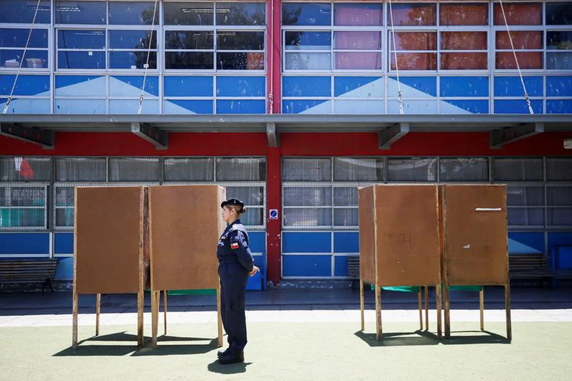 A Chilean Navy officer stands guard next to voting booths before the constitutional referendum which will be held on December 17, in Valparaiso, Chile, December 15, 2023. REUTERS/Rodrigo Garrido
