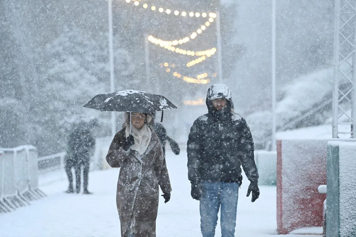 People walking in the snow triggered by Storm Bert, in Edinburgh, Scotland, on Nov 23.