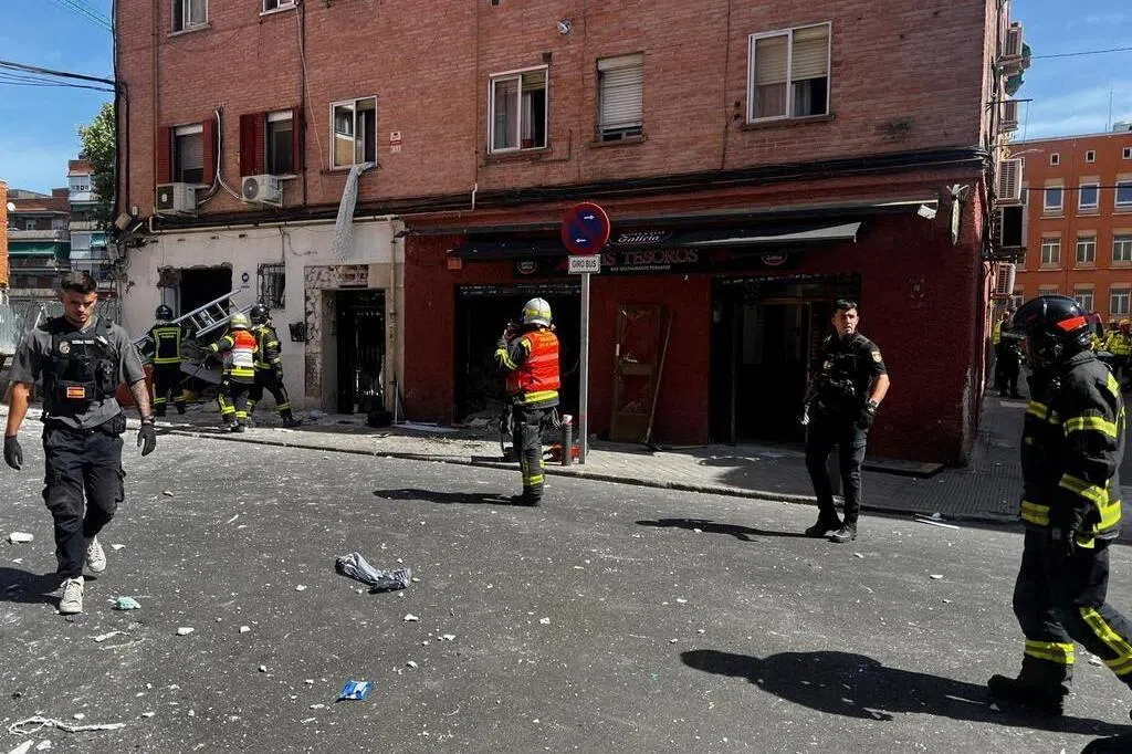 Firefighters working at the site of the cafe blast in Madrid.