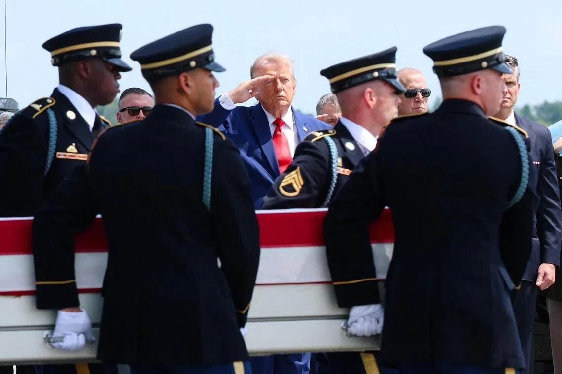 DOVER, DELAWARE - JULY 22: U.S. President Donald Trump (C) salutes as members of a U.S. Army carry team move the flag-draped transfer case holding the remains of Army Pvt. Isabella Gonzales, of Carrollton, Texas, during a dignified transfer at Dover Air Force Base July 22, 2026 in Dover, Delaware. Pvt. Gonzales, who was assigned to 1st Battalion, 57th Air Defense Artillery Regiment, 52nd Air Defense Artillery Brigade, 10th Army Air Missile Defense Command in Ansbach, Germany, was killed in action during an enemy attack on July 17, 2026, at Muwaffaq Salti Air Base in Jordan.   Kevin Dietsch/Getty Images/AFP (Photo by Kevin Dietsch / GETTY IMAGES NORTH AMERICA / Getty Images via AFP)