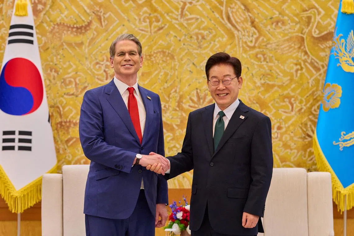 South Korean President Lee Jae Myung shakes hands with U.S. Treasury Secretary Scott Bessent during their meeting at the Presidential Blue House in Seoul, South Korea, May 13, 2026.    The Presidential Blue House/Yonhap via REUTERS
