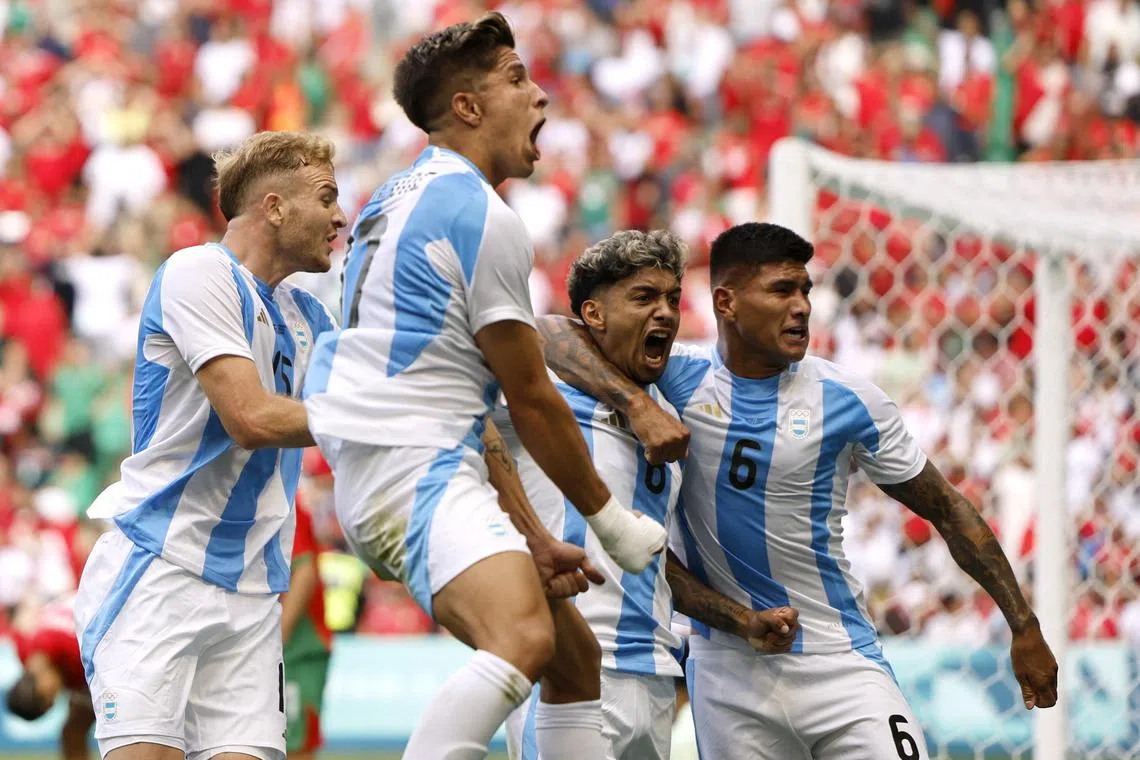 Cristian Medina of Argentina celebrates scoring their second goal in the late 2-2 draw with Morocco.