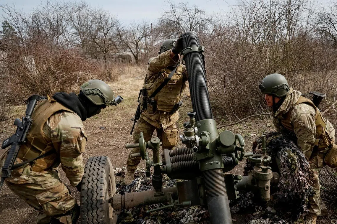 A March 2023 photo shows servicemen with the Freedom of Russia Legion preparing to fire a mortar at a Russian military position,  in Ukraine's Donetsk region, amid Moscow's invasion of its neighbour.