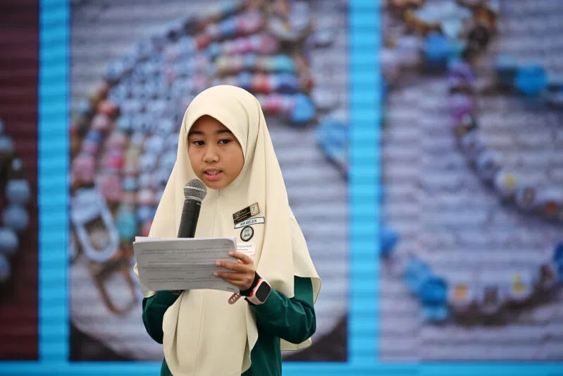 Nor Adeleia Noorhakim from Madrasah Irsyad Zuhri Islamiah sharing on stage at the Straits Times School Pocket Money Fund annual appreciation lunch.