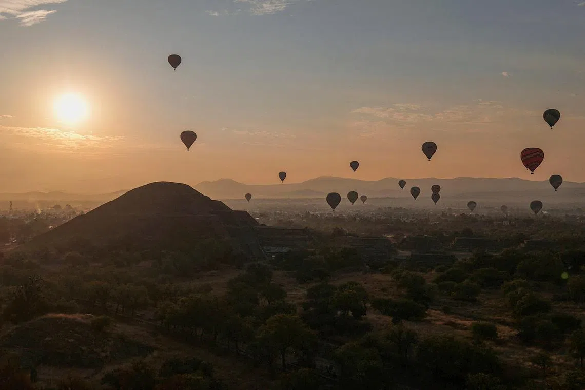 A drone view showing hot air balloons floating near the Teotihuacan pyramids after the area was closed, following a shooting a day earlier in which a gunman killed a Canadian woman and wounded several others before killing himself, at one of the country's most visited tourist sites, in San Martin de las Piramides on the outskirts of Mexico City, Mexico, April 21.