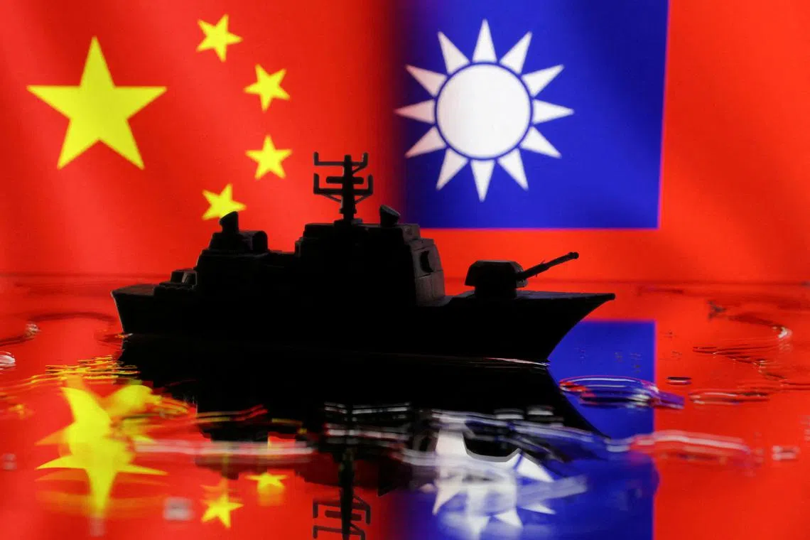 FILE PHOTO: A Navy miniature is seen in front of displayed Chinese and Taiwanese flags in this illustration taken, April 11, 2023. REUTERS/Dado Ruvic/Illustration/File Photo