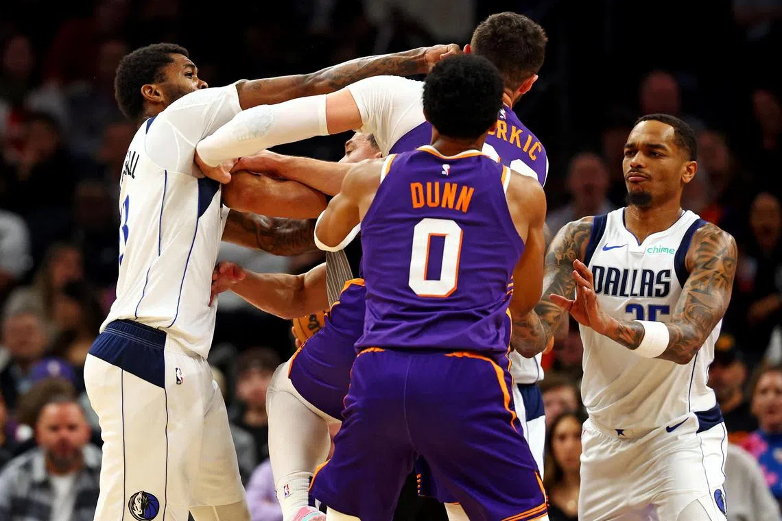 Dallas Mavericks forward Naji Marshall (13) punching Phoenix Suns centre Jusuf Nurkic (20) during the third quarter on Dec 27.   