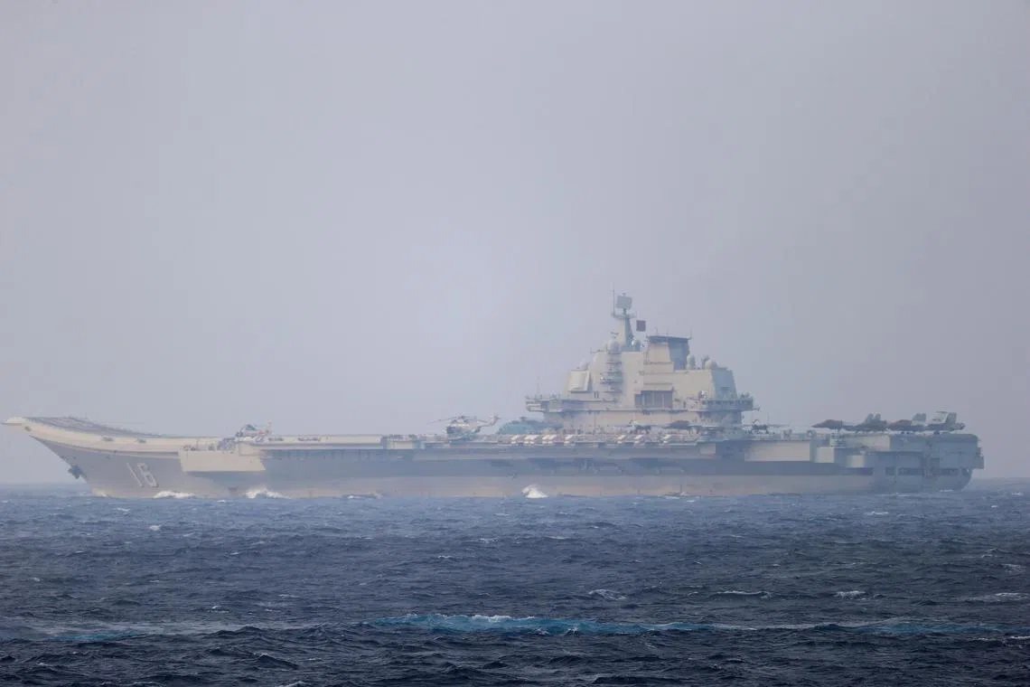 Taiwan said a Chinese aircraft carrier group sailed through the Taiwan Strait, after passing through waters near the Taiwan-controlled Pratas islands.