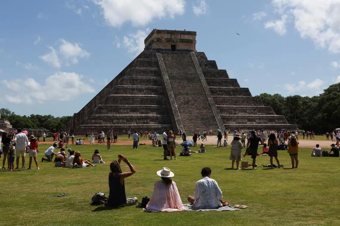 People gathering to watch the solar eclipse from the Chichen Itza archaeological zone, in Piste, Mexico, Oct 14, 2023. 