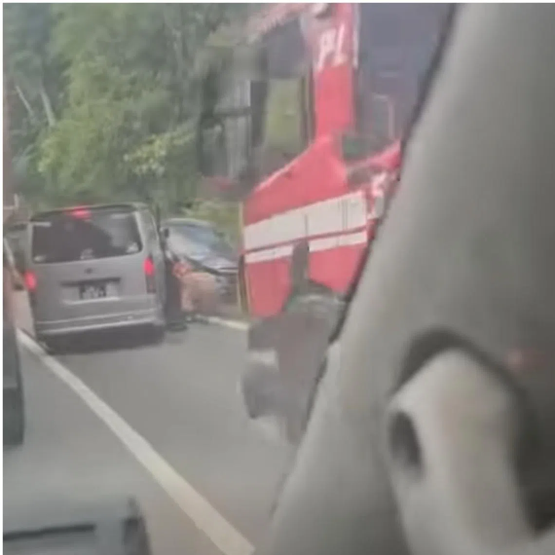 A video uploaded on the Singapore Incidents Facebook group shows a van and a car facing opposite directions in a crash on the side of the road.