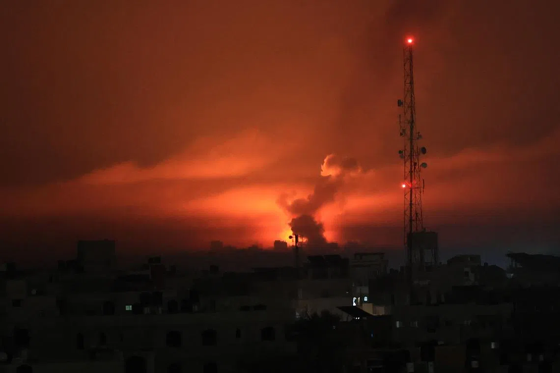 A fireball erupts during overnight Israeli bombardment in the Gaza Strip on Oct 24.