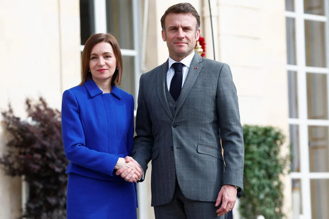 Moldova's President Maia Sandu shakes hands with French President Emmanuel Macron before a meeting at the Elysee Palace in Paris, France, March 7, 2024. REUTERS/Gonzalo Fuentes