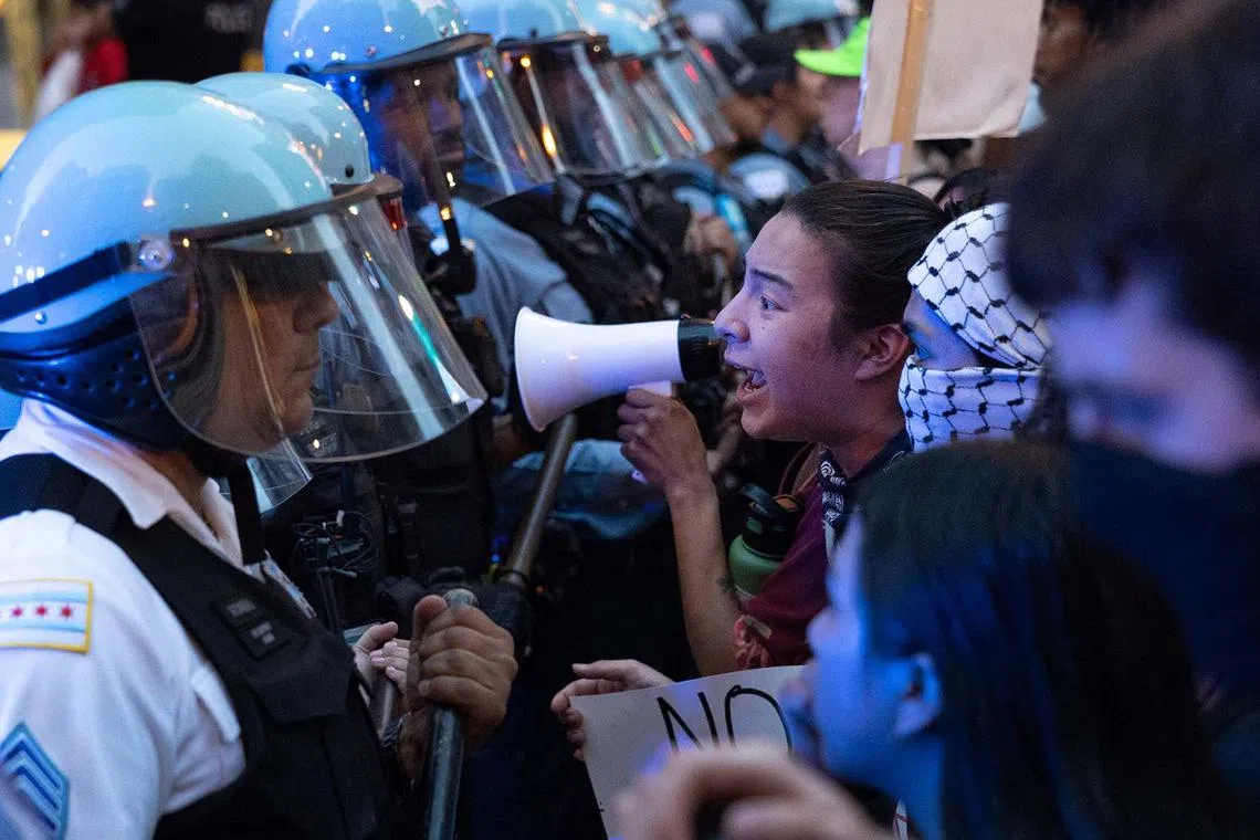 Police officers facing off with immigrant rights protesters on June 10, 2025, in Chicago, Illinois. The protest is one of many sparking up around the country as the Trump administration pushes to increase apprehensions of immigrants. 