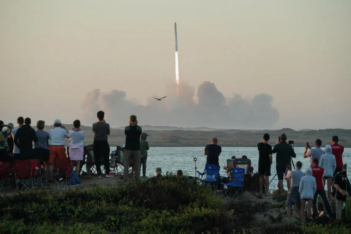 People watch as SpaceX's next-generation Starship spacecraft atop its powerful Super Heavy rocket lifts off from the company's Boca Chica launchpad on an uncrewed test flight on Nov 18, 2023.