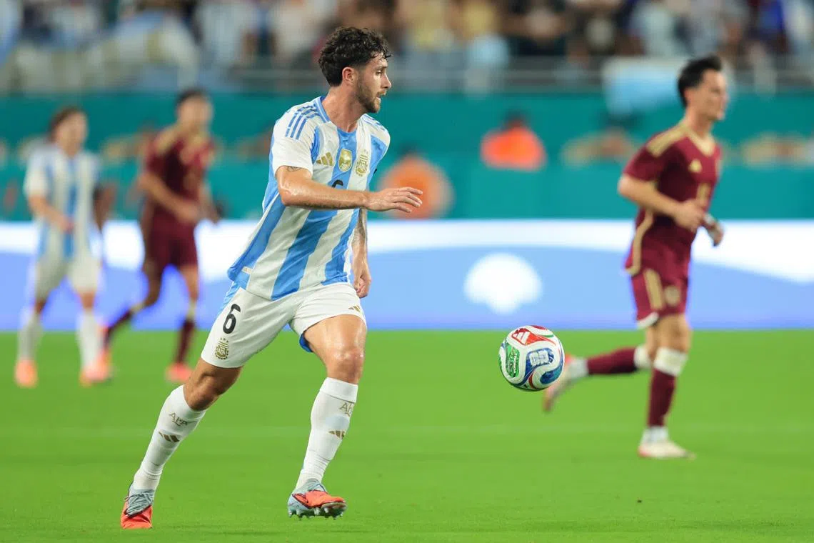 Oct 10, 2025; Miami Gardens, Florida, USA; Argentina defender Marcos Senesi (6) dribbles the ball against Venezuela during the first half at Hard Rock Stadium. Mandatory Credit: Sam Navarro-Imagn Images