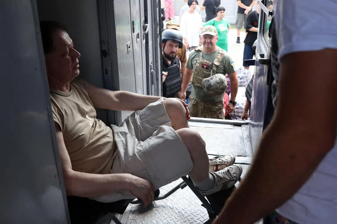 A resident boarding a train for evacuation, in Pokrovsk, in Ukraine's Donetsk region.